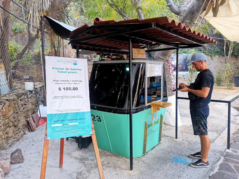 Allan standing in front of the ticket booth in the shape of a cable car