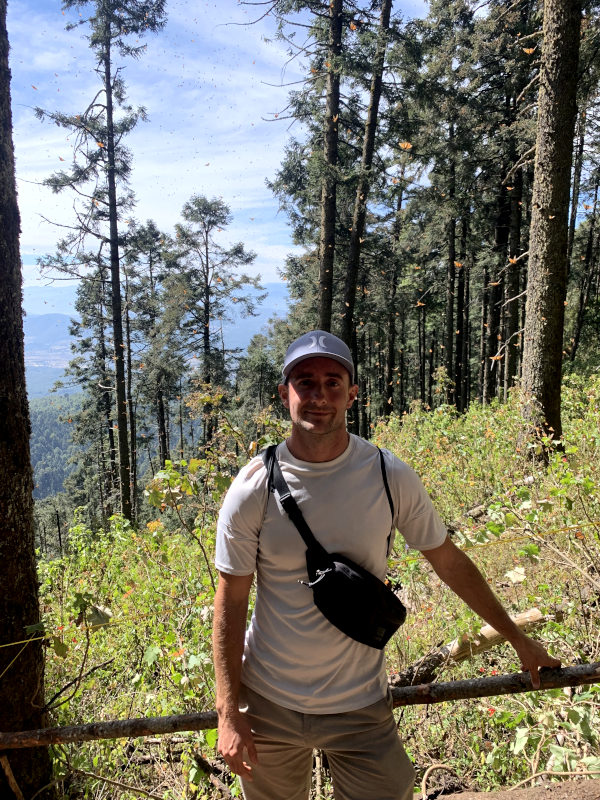 Allan standing in front of a hilltop view at Sierra Chincua