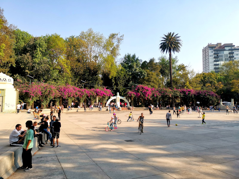 A square in Parque Mexico with people playing in Condesa