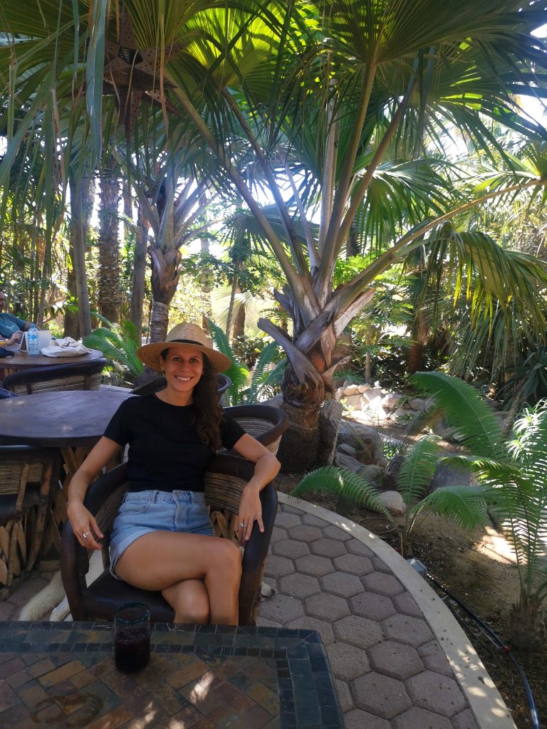 A woman sitting in a seat at la esquina cafe