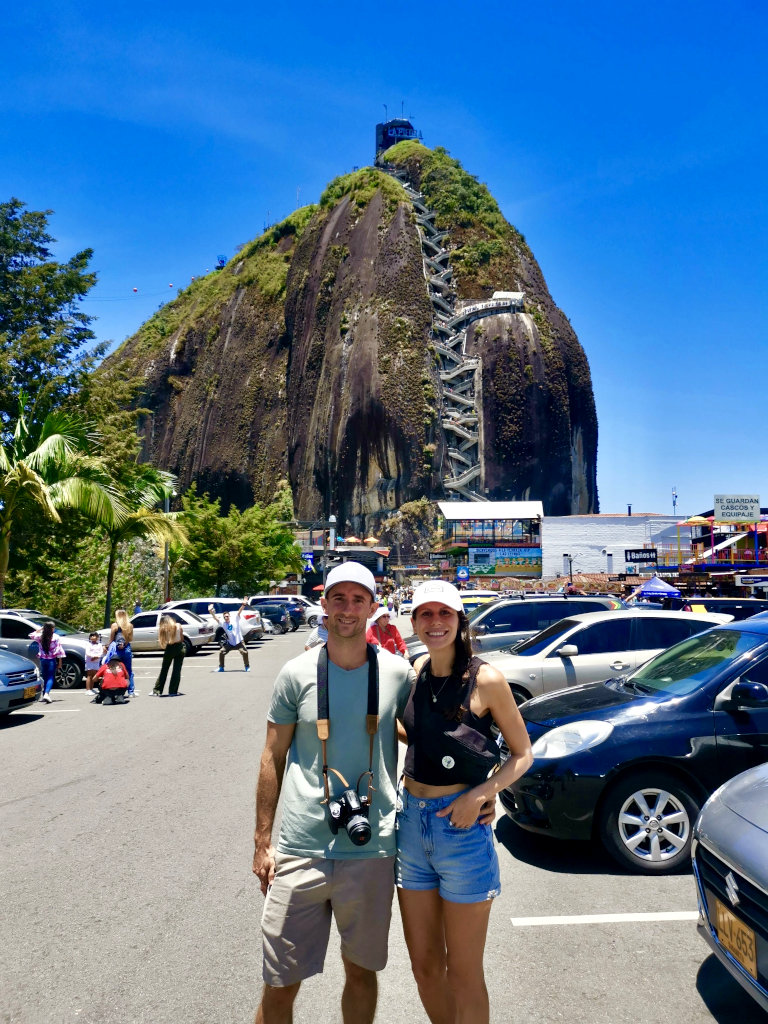 A couple posing in front of El Peñol 