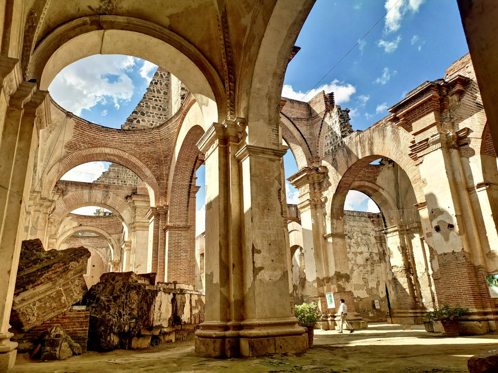 A man walking through the ruins of an old church in Antigua Guatemala