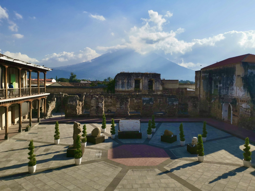 A view of a volcano covered in clouds in the courtyard of the Munag museum