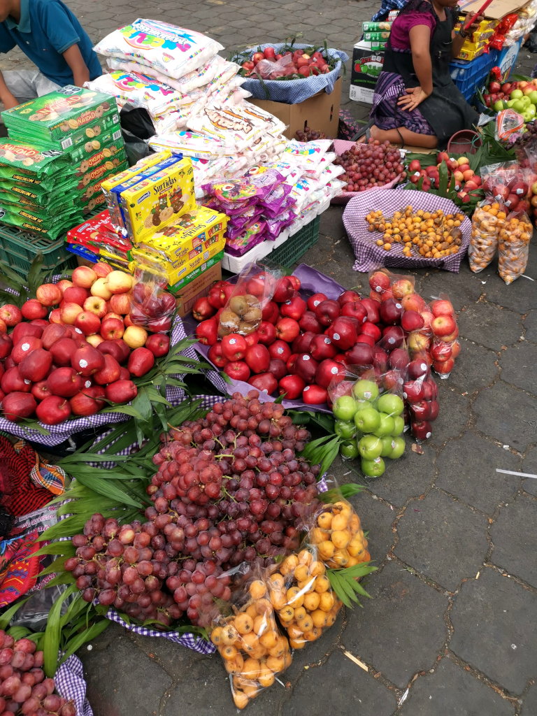 A woman selling grapes at a market as part of a New Years Eve tradition in Antigua Guatemala