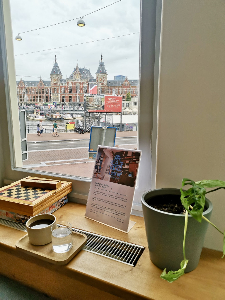 A cup of black coffee sitting on a window sill at Priesthood Cafe, one of the best hidden gem cafes in Amsterdam's city center.