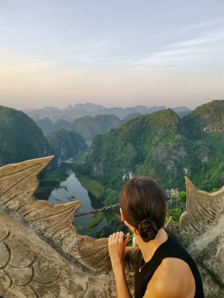 Katharina looking out over the winding Ngo Dong River and limestone karsts from the Lying Dragon statue at the top of Hang Mua.