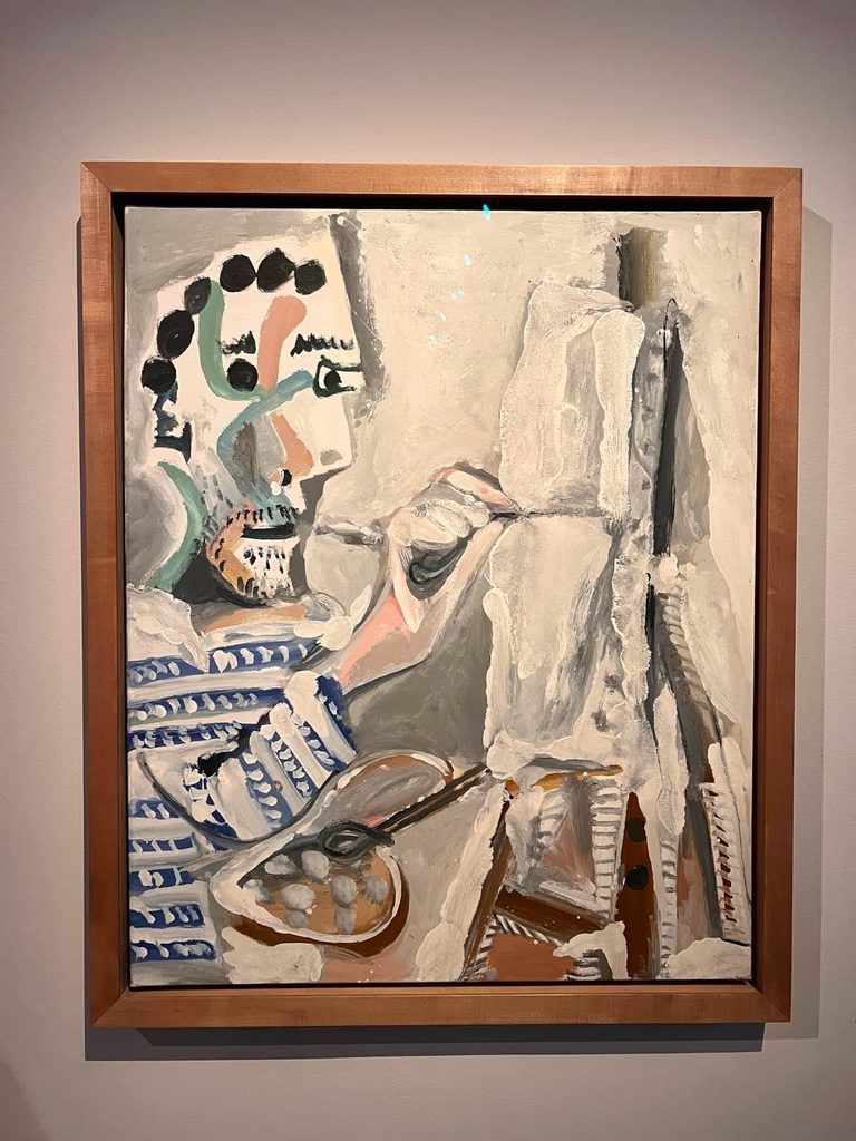 A framed abstract painting by Pablo Picasso depicting a painter with a palette and brush working in front of a canvas, on display at the Picasso Museum in Barcelona.